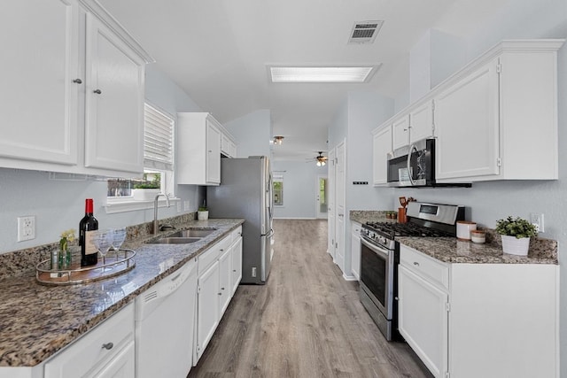 kitchen featuring ceiling fan, visible vents, white cabinets, light wood finished floors, and stainless steel appliances
