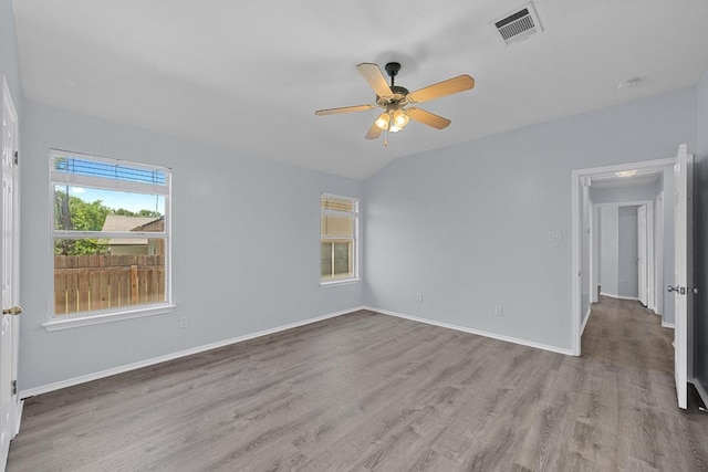 unfurnished room featuring visible vents, a ceiling fan, baseboards, and wood finished floors