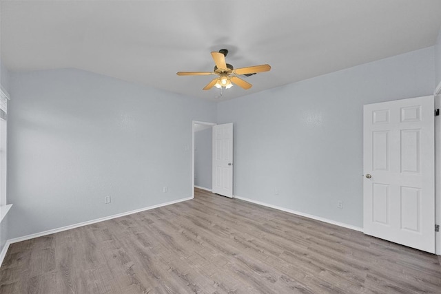 spare room with baseboards, ceiling fan, and wood finished floors