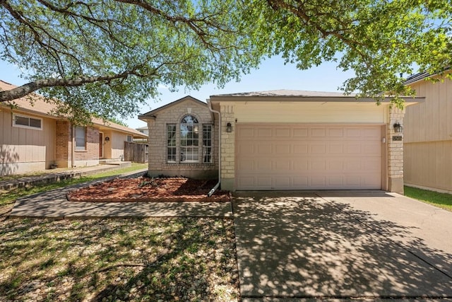 single story home featuring an attached garage and driveway
