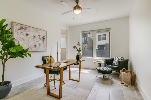 office area with baseboards and ceiling fan