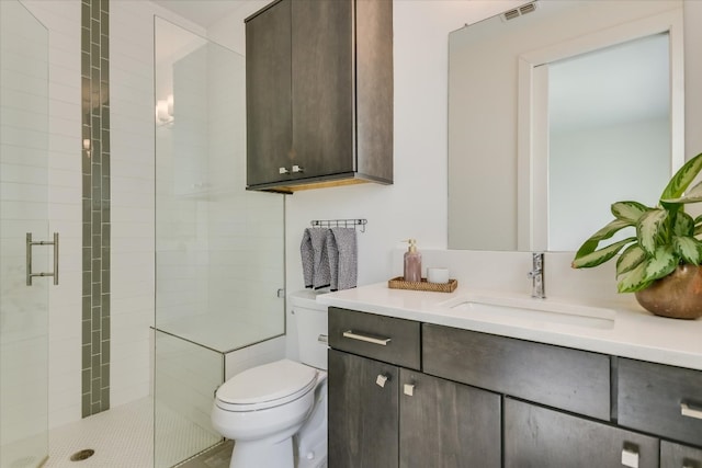 full bathroom with vanity, toilet, visible vents, and a stall shower