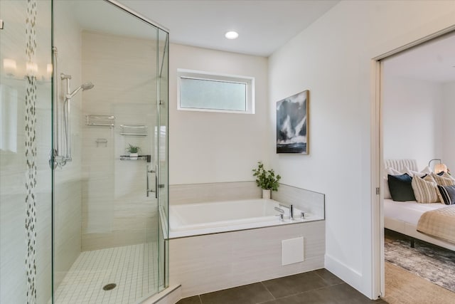 ensuite bathroom with tile patterned flooring, a stall shower, a garden tub, and connected bathroom
