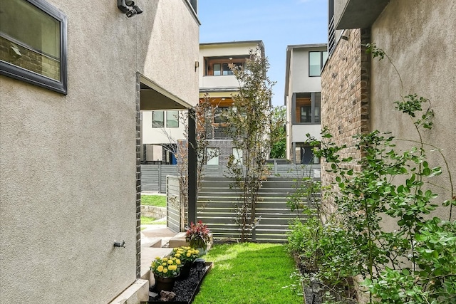 exterior space with stucco siding and fence