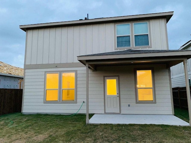 back of property featuring board and batten siding and a patio area