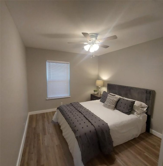 bedroom featuring baseboards, ceiling fan, and wood finished floors