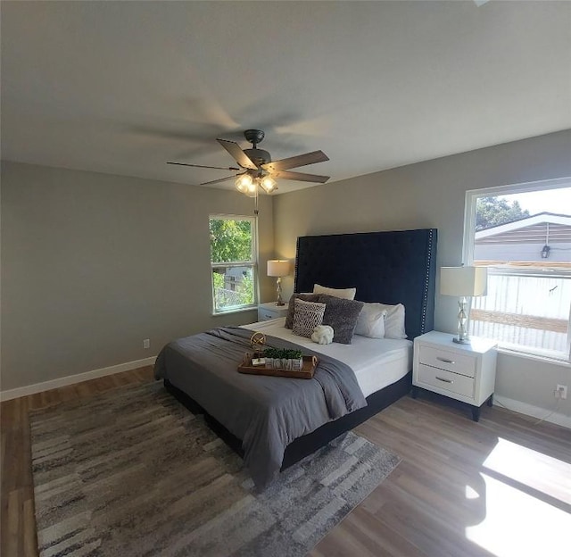 bedroom with baseboards, a ceiling fan, and wood finished floors
