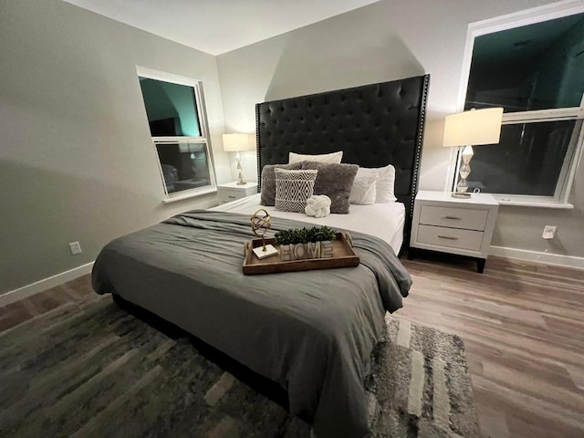 bedroom featuring baseboards and wood finished floors