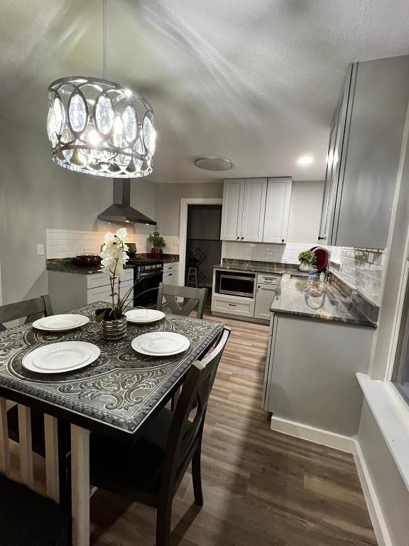 dining area featuring a notable chandelier and dark wood finished floors