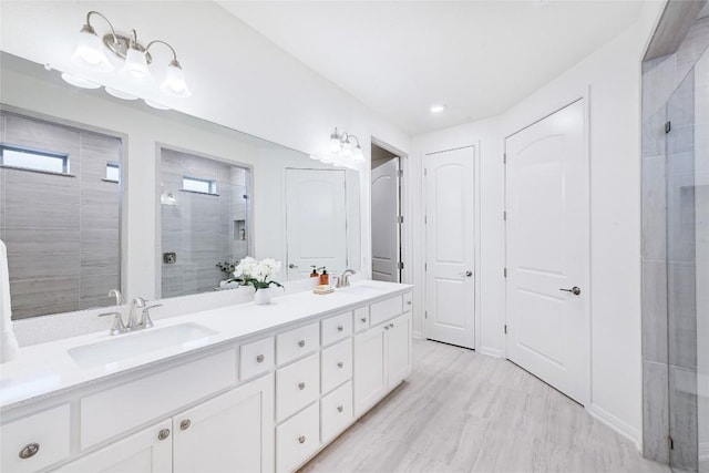 19020 Fernando Trl, Austin, TX 78738 - bathroom featuring a shower stall, double vanity, and recessed lighting