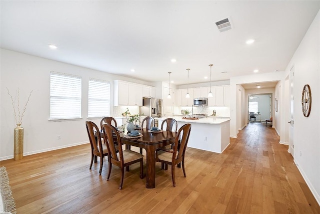 19020 Fernando Trl, Austin, TX 78738 - dining area with healthy amount of natural light, light wood finished floors, recessed lighting, and baseboards