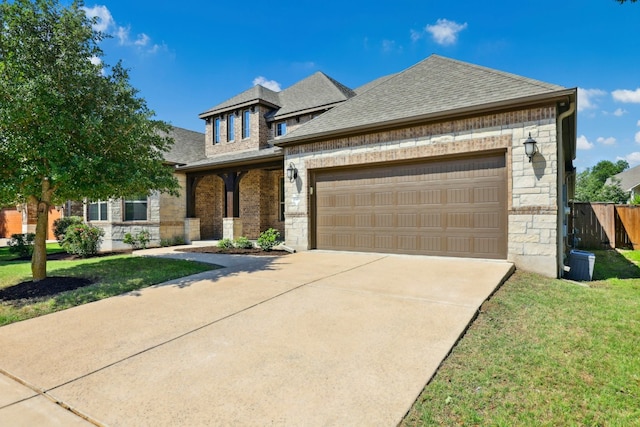10408 Nicolet Way, Austin, TX 78717 - view of front of property with stone siding, a shingled roof, a garage, and concrete driveway