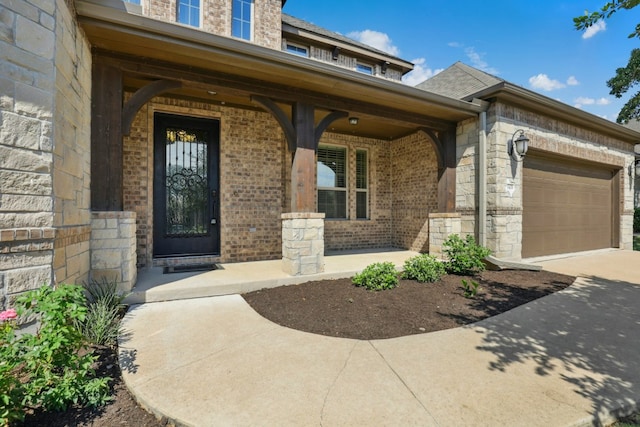 10408 Nicolet Way, Austin, TX 78717 - property entrance featuring a porch, concrete driveway, brick siding, an attached garage, and stone siding