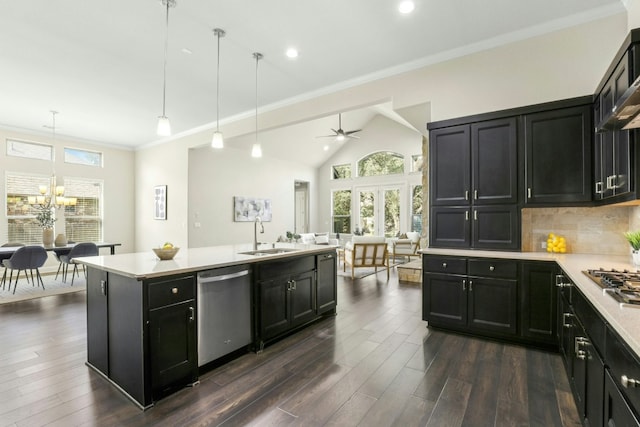 10408 Nicolet Way, Austin, TX 78717 - kitchen featuring stainless steel appliances, a sink, a chandelier, dark cabinetry, and light countertops