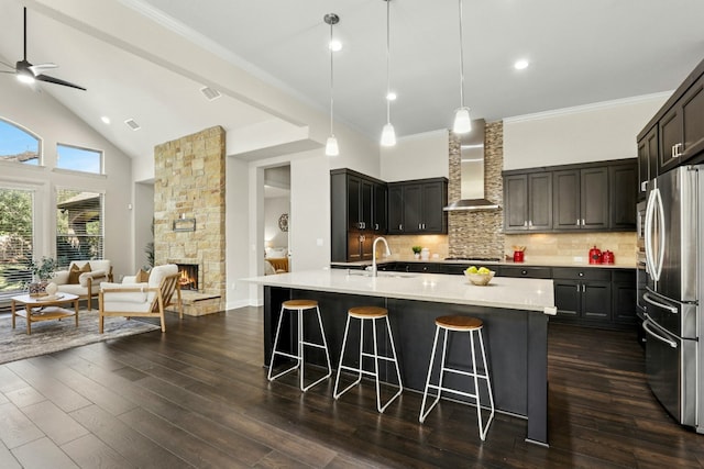 10408 Nicolet Way, Austin, TX 78717 - kitchen with wall chimney exhaust hood, freestanding refrigerator, open floor plan, a kitchen bar, and backsplash