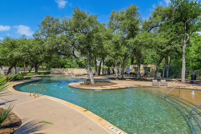 10408 Nicolet Way, Austin, TX 78717 - community pool with a patio and view of wooded area