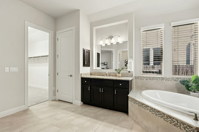 10408 Nicolet Way, Austin, TX 78717 - full bathroom featuring vanity, a garden tub, tile patterned floors, and a walk in closet