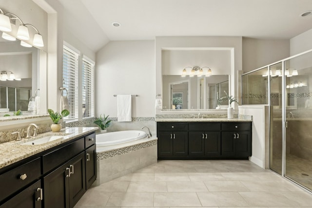 10408 Nicolet Way, Austin, TX 78717 - full bathroom featuring two vanities, a stall shower, a garden tub, vaulted ceiling, and tile patterned floors