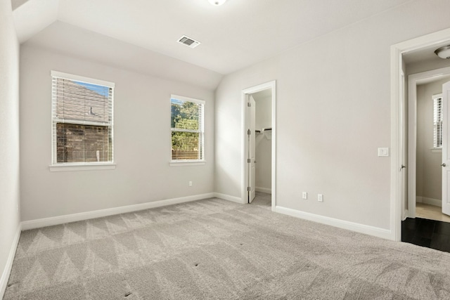 10408 Nicolet Way, Austin, TX 78717 - unfurnished bedroom featuring carpet floors, vaulted ceiling, and a walk in closet