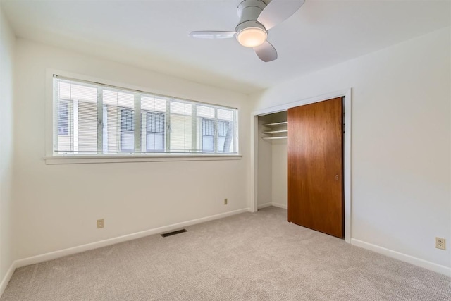unfurnished bedroom featuring ceiling fan, visible vents, baseboards, a closet, and carpet flooring