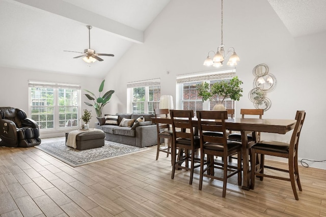 8011 Tantara Ct, Austin, TX 78729 - dining area with high vaulted ceiling, ceiling fan, beam ceiling, a chandelier, and light wood finished floors