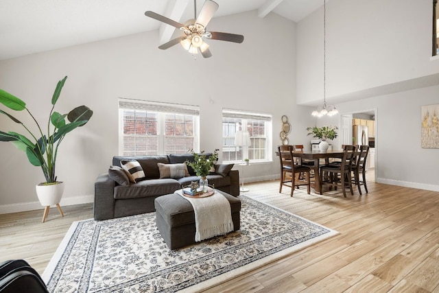 8011 Tantara Ct, Austin, TX 78729 - living room with high vaulted ceiling, baseboards, a chandelier, beam ceiling, and light wood-style floors