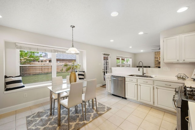 8011 Tantara Ct, Austin, TX 78729 - kitchen with stainless steel appliances, a sink, a peninsula, white cabinetry, and recessed lighting