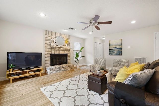 8011 Tantara Ct, Austin, TX 78729 - living room featuring a ceiling fan, wood finished floors, baseboards, a brick fireplace, and recessed lighting