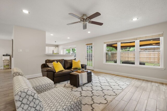 8011 Tantara Ct, Austin, TX 78729 - living area featuring baseboards, a ceiling fan, light wood-type flooring, and recessed lighting