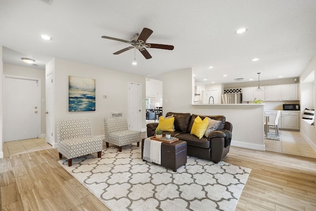 8011 Tantara Ct, Austin, TX 78729 - living area with light wood-type flooring, ceiling fan, recessed lighting, and baseboards