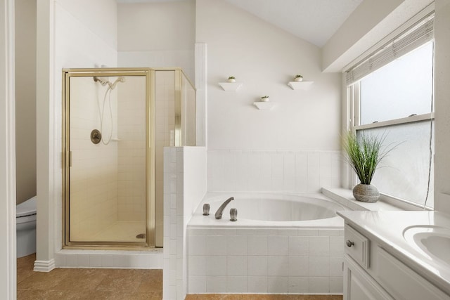 8011 Tantara Ct, Austin, TX 78729 - bathroom with a stall shower, a bath, vanity, lofted ceiling, and toilet