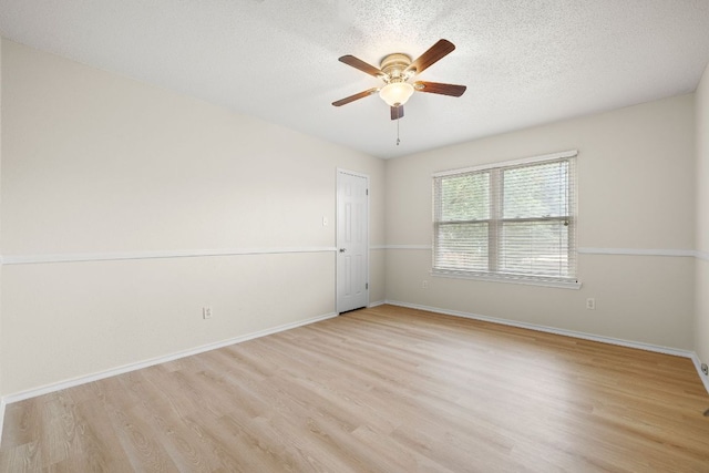 8011 Tantara Ct, Austin, TX 78729 - empty room with ceiling fan, wood finished floors, baseboards, and a textured ceiling