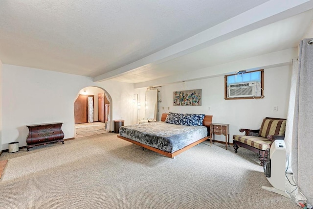 carpeted bedroom featuring arched walkways, beam ceiling, and cooling unit