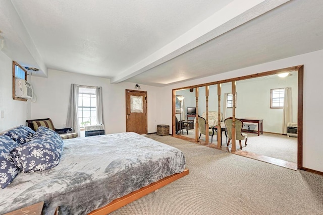 carpeted bedroom with baseboards and beam ceiling