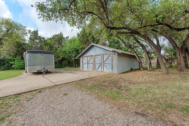 detached garage featuring fence