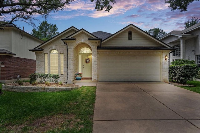 ranch-style house with an attached garage, driveway, stone siding, and a front lawn