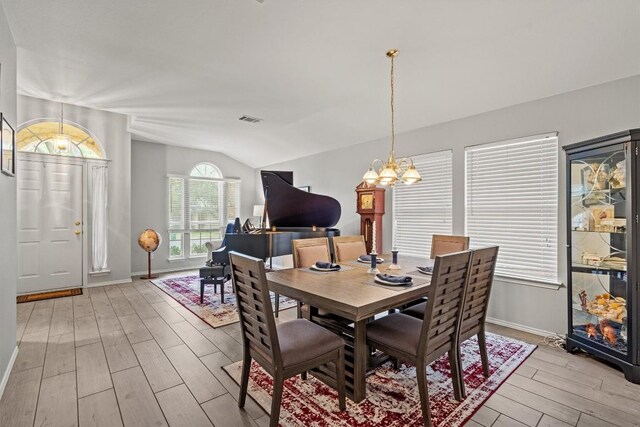 12804 Council Bluff Dr, Austin, TX 78727 - dining area featuring light wood finished floors, a chandelier, lofted ceiling, and baseboards