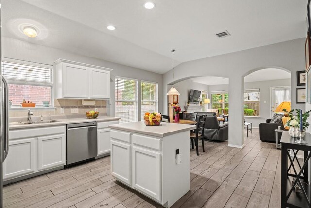 12804 Council Bluff Dr, Austin, TX 78727 - kitchen featuring stainless steel dishwasher, arched walkways, a sink, light wood-style flooring, and recessed lighting