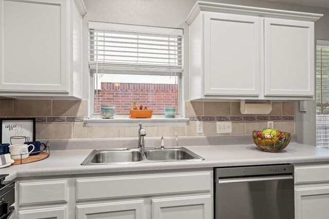 12804 Council Bluff Dr, Austin, TX 78727 - kitchen featuring a sink, stainless steel dishwasher, white cabinets, backsplash, and light countertops