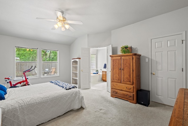 bedroom with light colored carpet, a ceiling fan, connected bathroom, and lofted ceiling