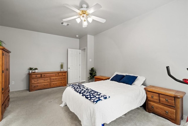 bedroom featuring visible vents, ceiling fan, and light carpet