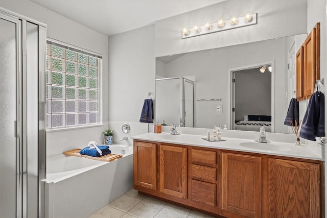 full bath featuring a garden tub, a stall shower, a sink, tile patterned floors, and ensuite bathroom