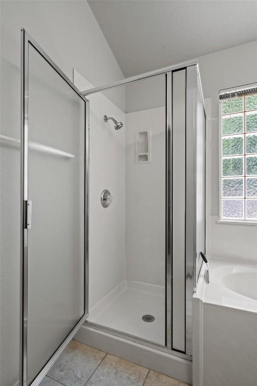 12804 Council Bluff Dr, Austin, TX 78727 - bathroom with a shower stall, tile patterned flooring, and a garden tub