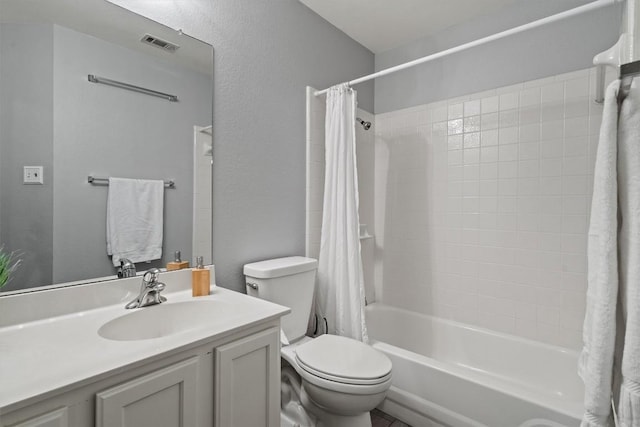 full bath featuring vanity, toilet, visible vents, and shower / bath combo with shower curtain