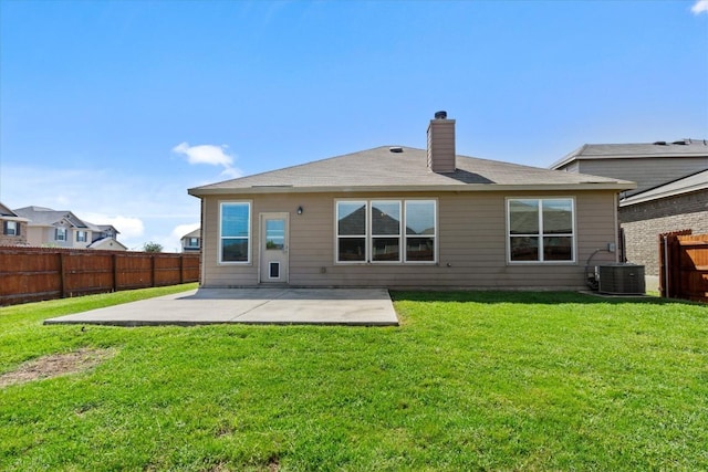 back of property featuring cooling unit, a fenced backyard, a chimney, a patio area, and a yard