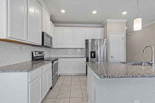 kitchen with a sink, white cabinets, ornamental molding, and stainless steel appliances