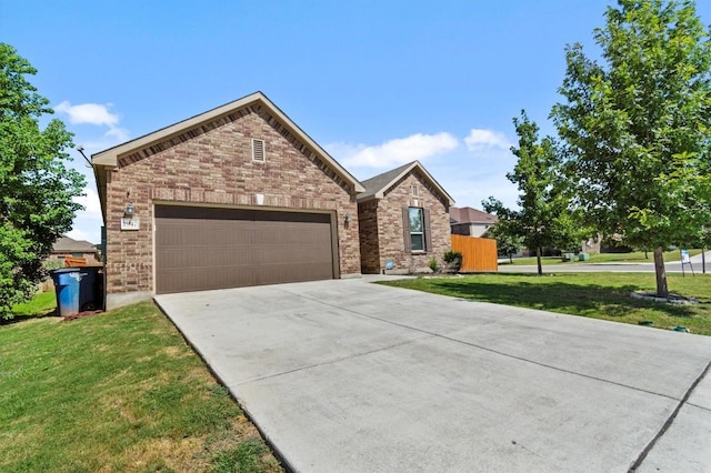view of front of house with brick siding, driveway, a front lawn, and a garage