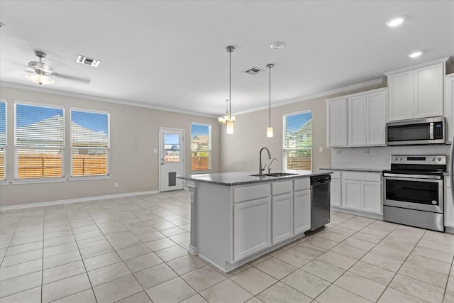 kitchen with visible vents, ornamental molding, a sink, light tile patterned floors, and stainless steel appliances