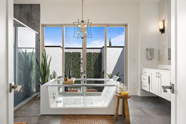 1304 High Lonesome, Leander, TX 78641 - full bathroom featuring a tub with jets, vanity, a chandelier, and baseboards