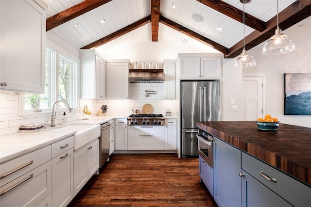4801 Balcones Dr, Austin, TX 78731 - kitchen featuring stainless steel appliances, dark wood finished floors, butcher block counters, pendant lighting, and decorative backsplash